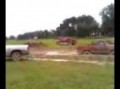 Dodge pulling an old ford out of mud