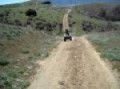 Father teaches his son how to ride a quad