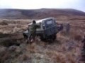 Old Landrover being winched out of pothole